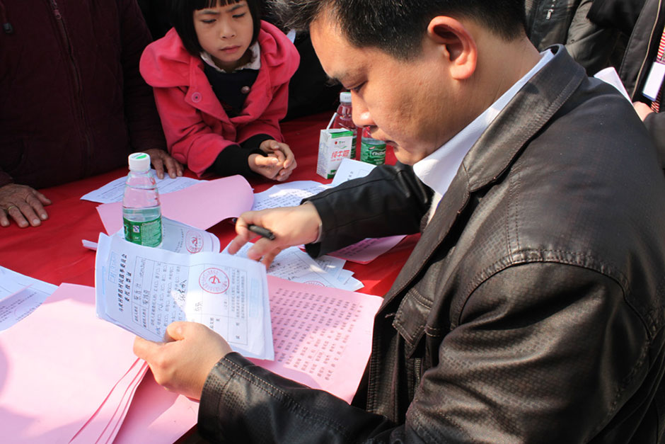 A voting official prepares absentee ballot voting certificates in Wukan, January 31, 2012.